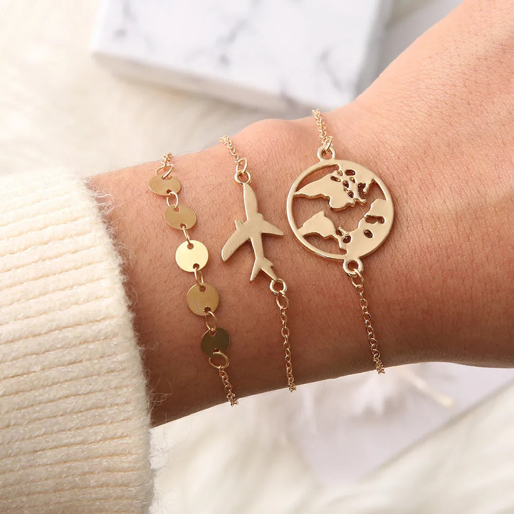 Three bohemian bracelets with heart-shaped aircraft map charms in alloy construction