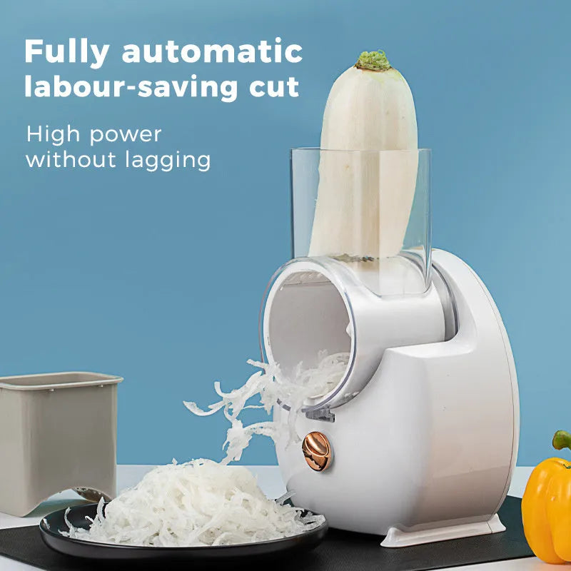 White electric vegetable slicer with rotary grater, blade barrel, and suction base on a kitchen counter.