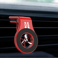 Black magnetic car phone holder clipped to a car air vent, showing a smartphone attached and the 360-degree rotating bracket.