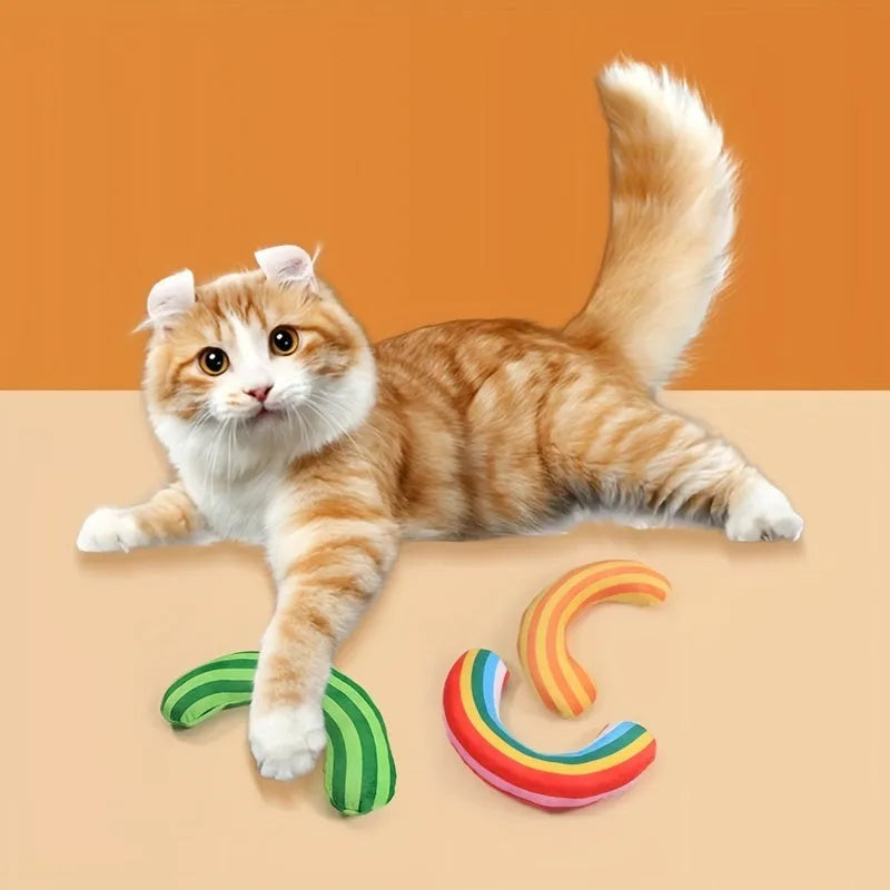 Green and yellow striped cat pillow beside a mouse-shaped noise toy with catnip