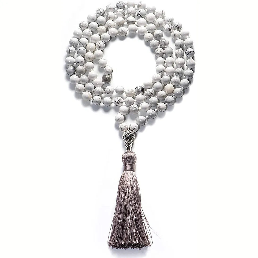 Long agate and amethyst gemstone tassel necklace with geometric pendant on a model.