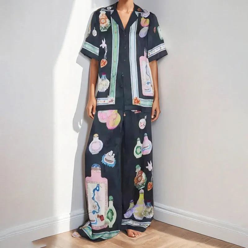 Black women's casual set with cartoon print, featuring a cardigan and trousers.