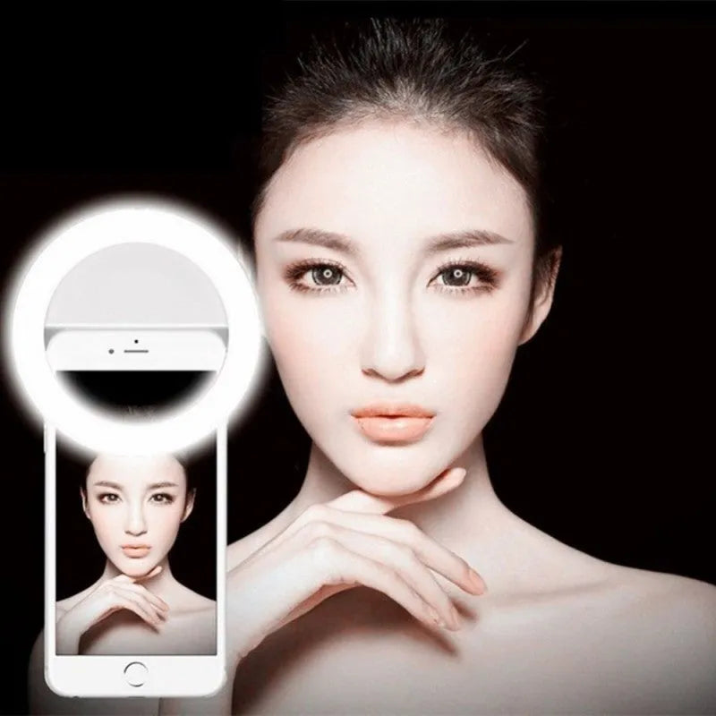 Green clip-on LED ring light attached to mobile phone for selfie photography lighting