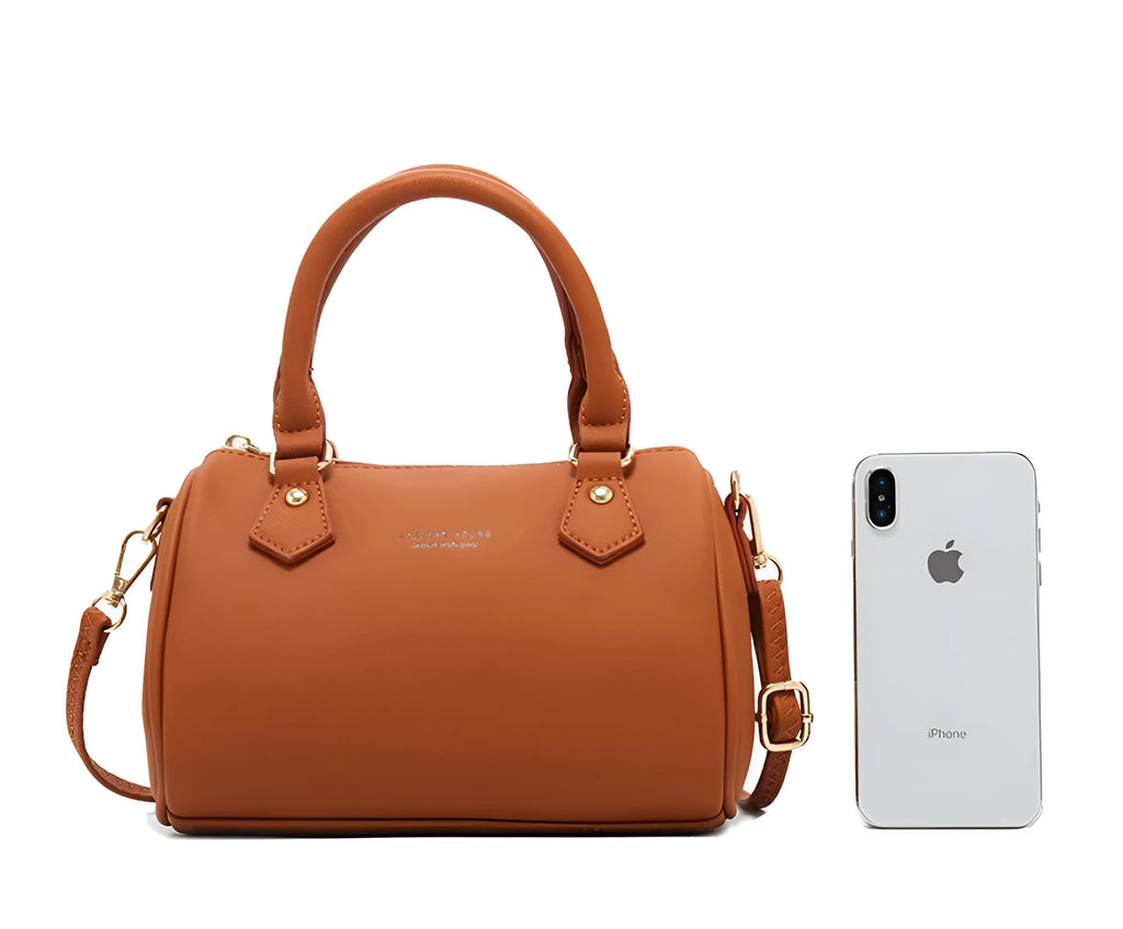 Ladies pillow crossbody bag in PU with zip closure and letter detail, shown in available colours.