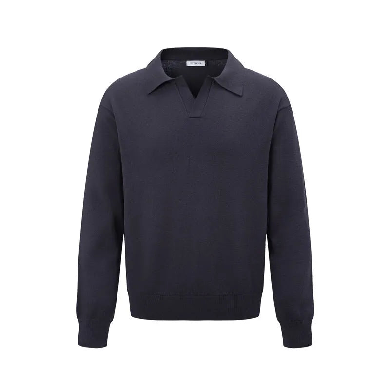 Loose fit long sleeve pullover sweater in black, dark grey, and cream colours on a hanger.