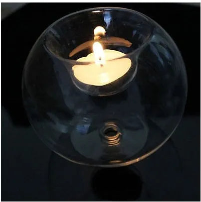 Handmade clear round hollow glass candle holder in European style on a table.