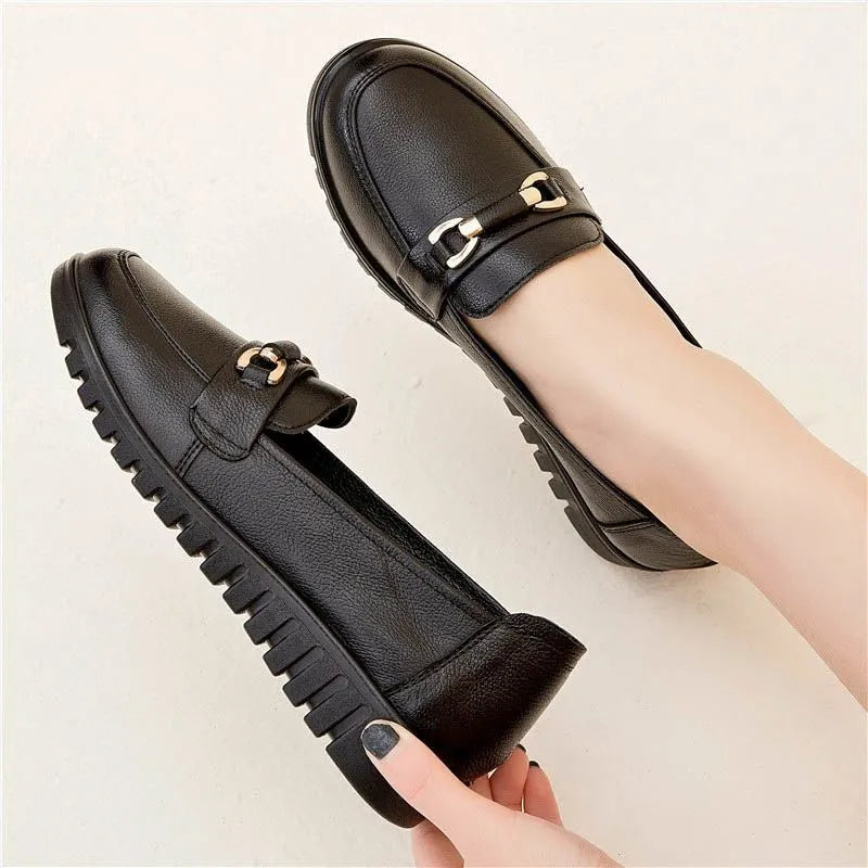 Black soft leather casual pumps with a round toe and low flat heel.