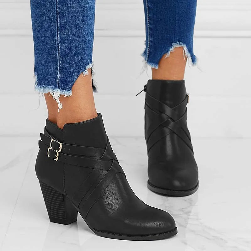 Plus size black short boot with side zipper, buckle, and a 7cm thick rubber heel.