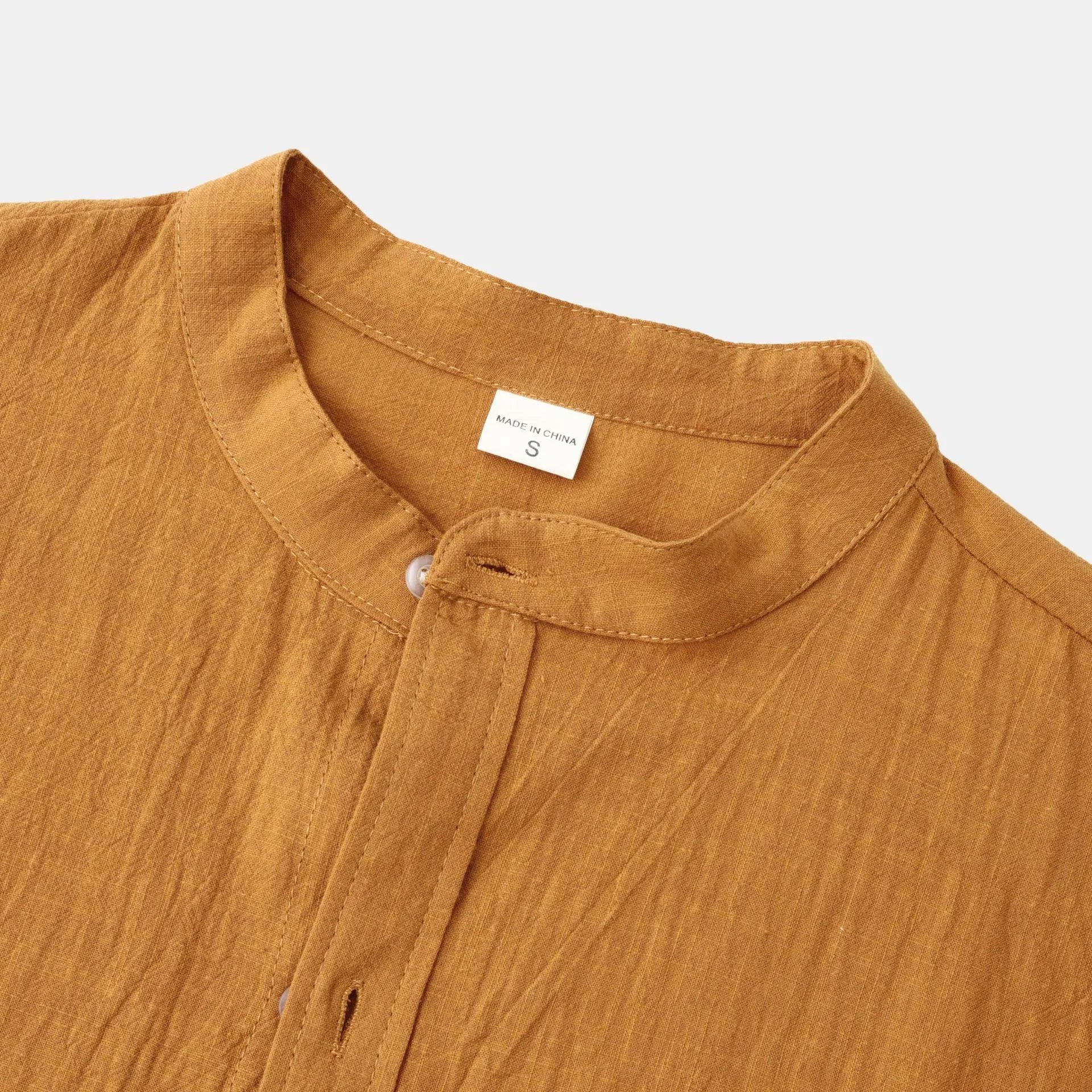 Brown men's slim fit long sleeve shirt and casual trousers on a hanger.