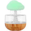 White USB-powered humidifier and essential oil diffuser with colour-changing night light on a table.