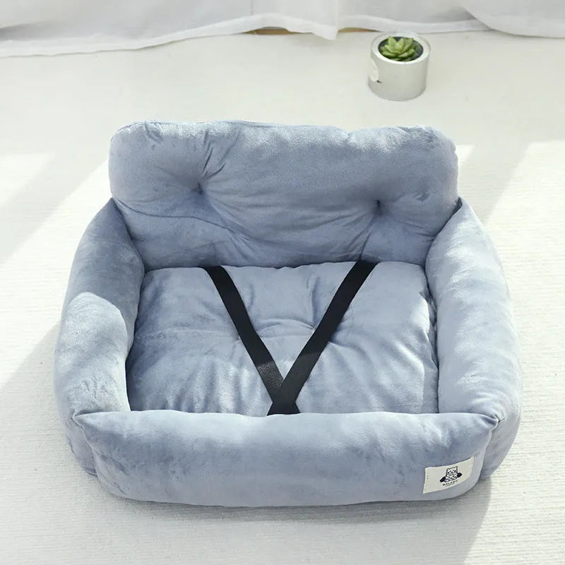 Grey and blue plaid cloth dog nest mounted in a car for pet travel.