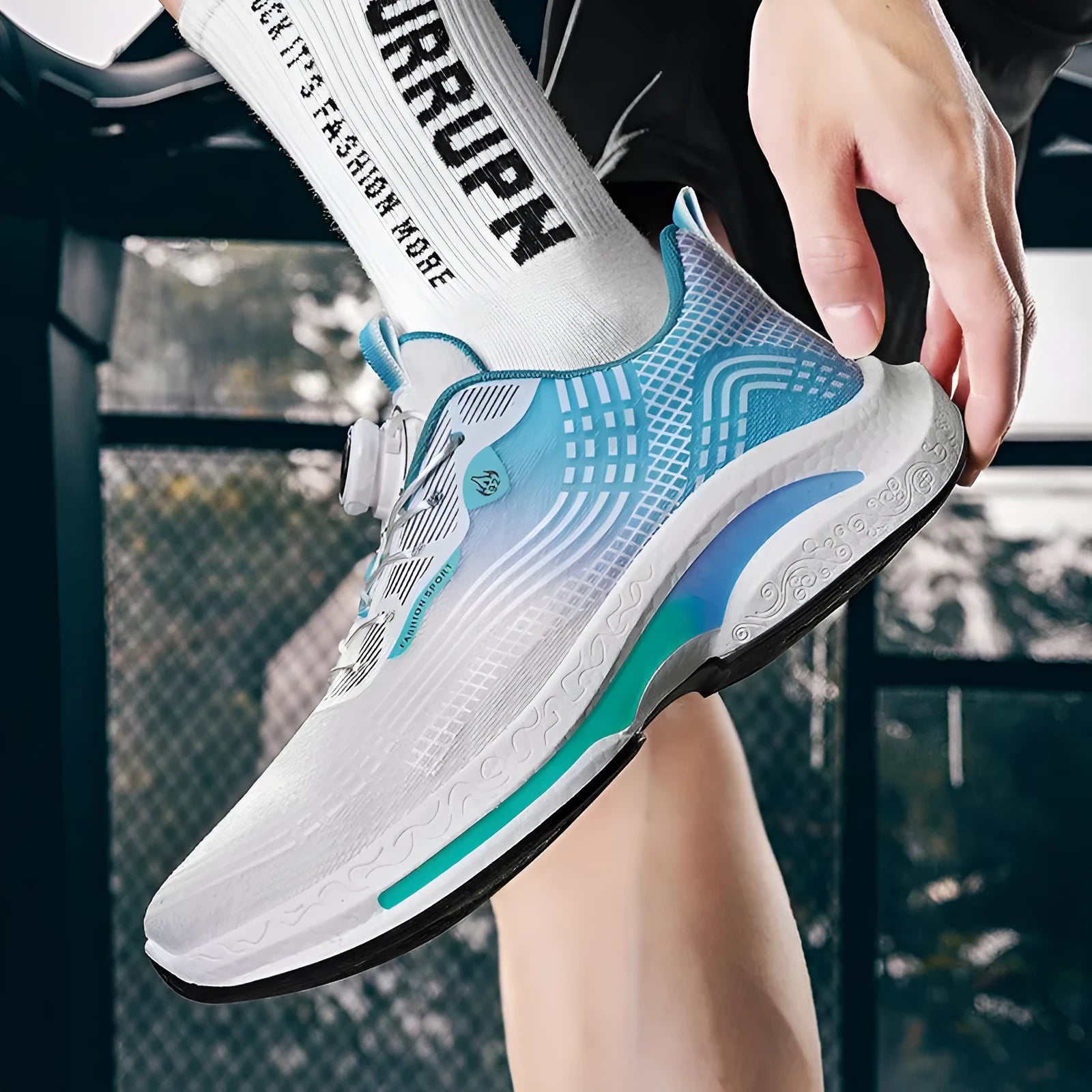 Men's low-top sneaker in black and blue colour with a rotating buckle closure and mesh upper.