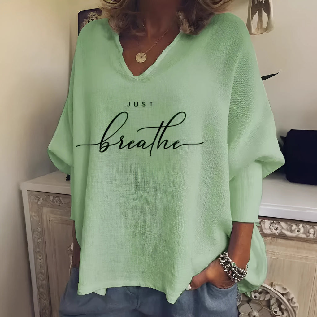 Woman wearing a loose V-neck long sleeve top in a digitally printed brushed silk fabric