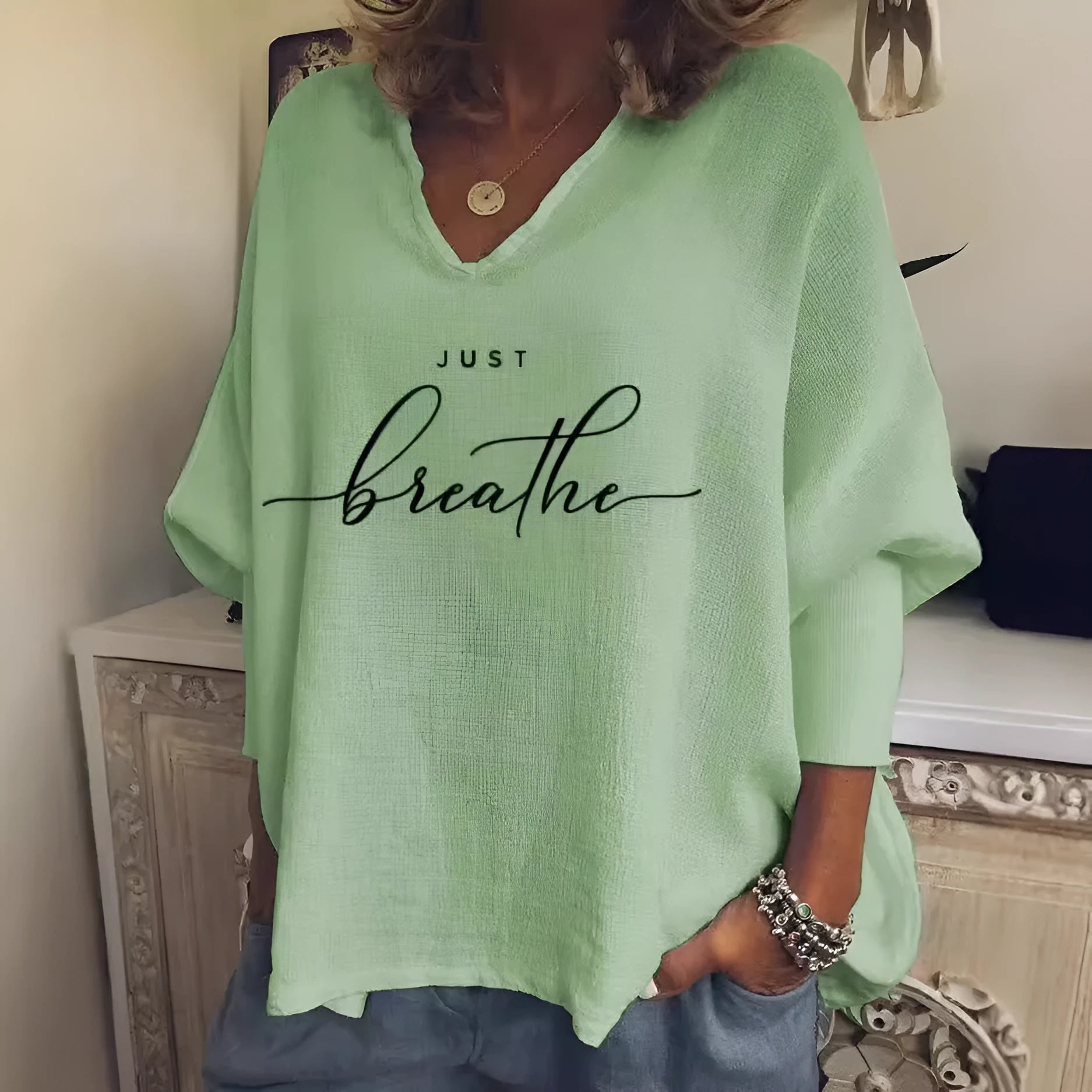 Woman wearing a loose V-neck long sleeve top in a digitally printed brushed silk fabric