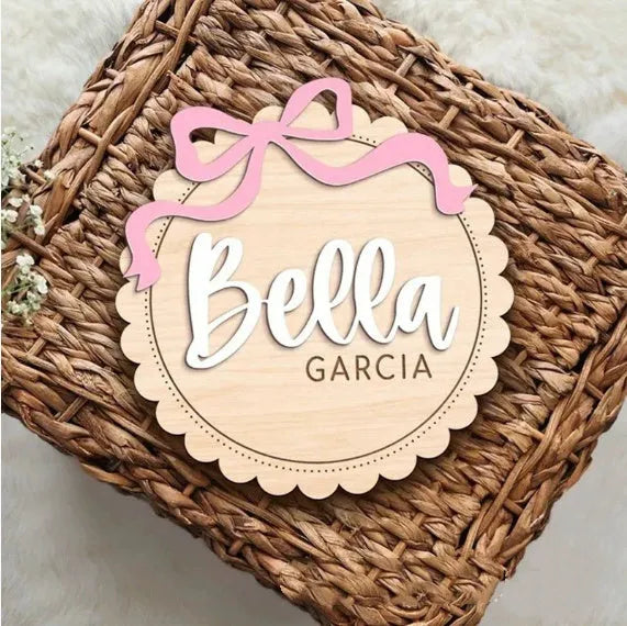 Square wooden baby room ornament with a customised name, shown in two size options.