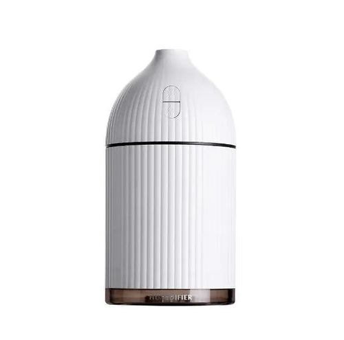 White USB aromatherapy diffuser and humidifier with LED light on a wooden desk
