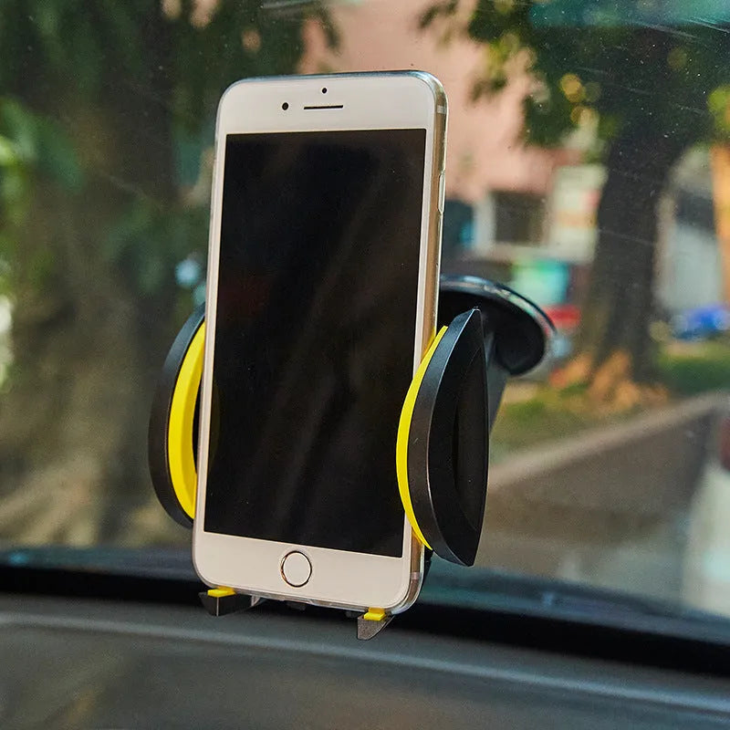 Blue U-shaped suction cup car phone holder with wide clamp arms, mounted on a dashboard holding a mobile phone.