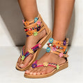 Women's ethnic style beaded petal sandals with floral decoration on a round toe PU upper.