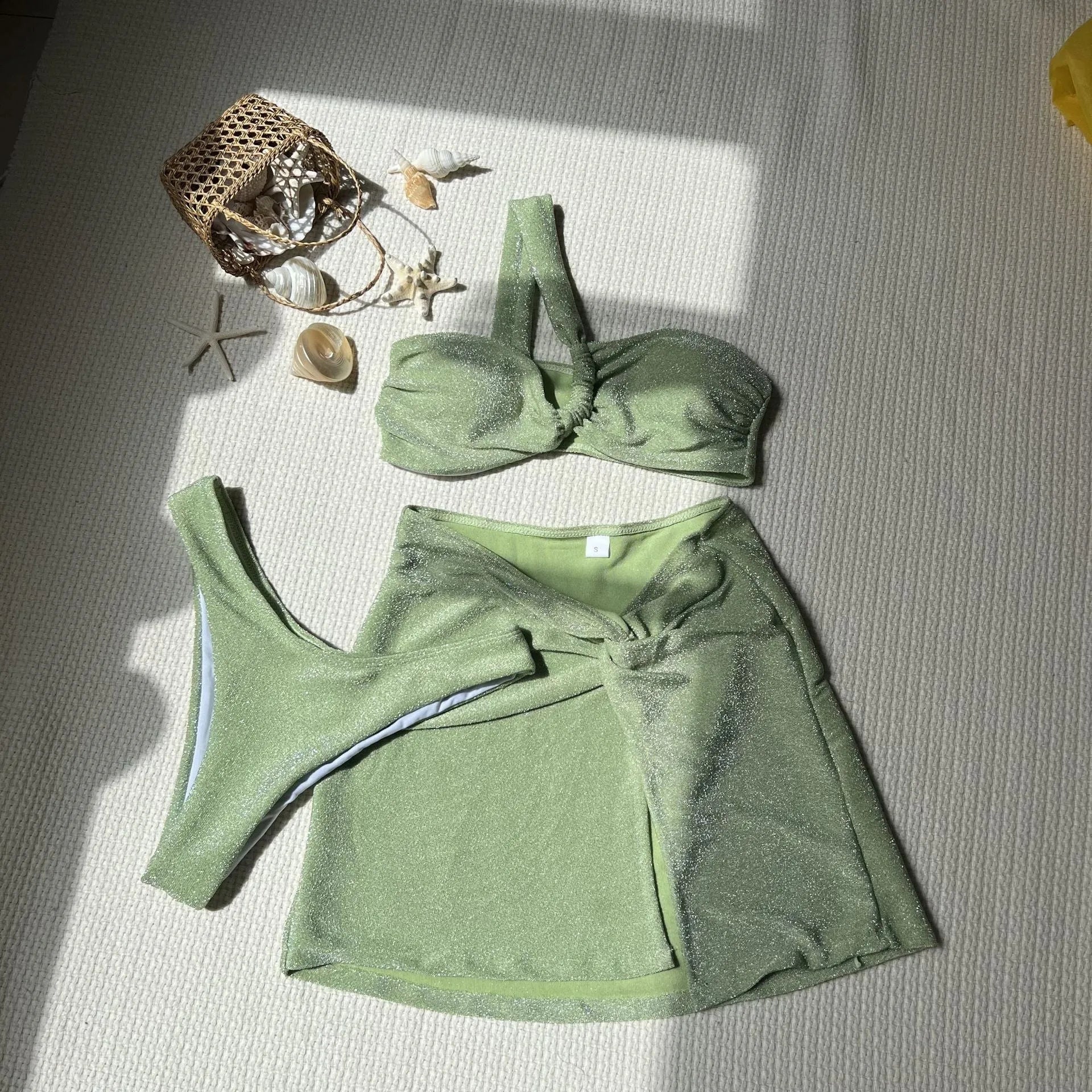 Women's light green one-shoulder tube top swimsuit set with matching pants and skirt