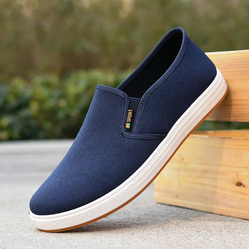Men's black and blue low-top canvas slip-on shoes with round toe design