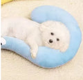Blue Question Mark shaped cat sleeping mat with integrated U-shaped neck support pillow on a cage floor.