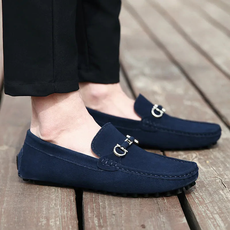 Men's black matte cowhide slip-on shoe with square toe and visible stitching on a plain background.