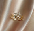 Adjustable open copper ring with a miniature double cross design inlaid with zircon stones.