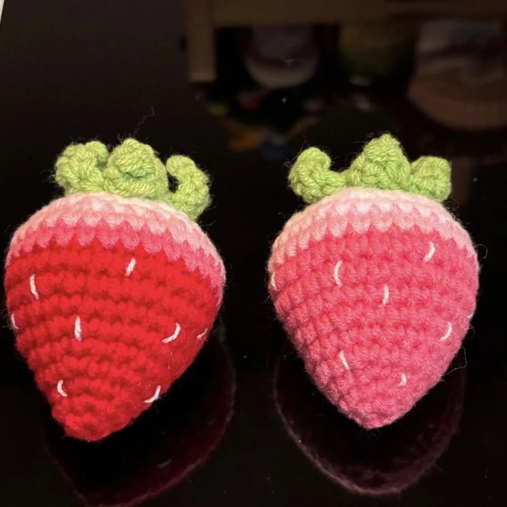 Soft plush strawberry-shaped pendant keychain in pink or red colour.