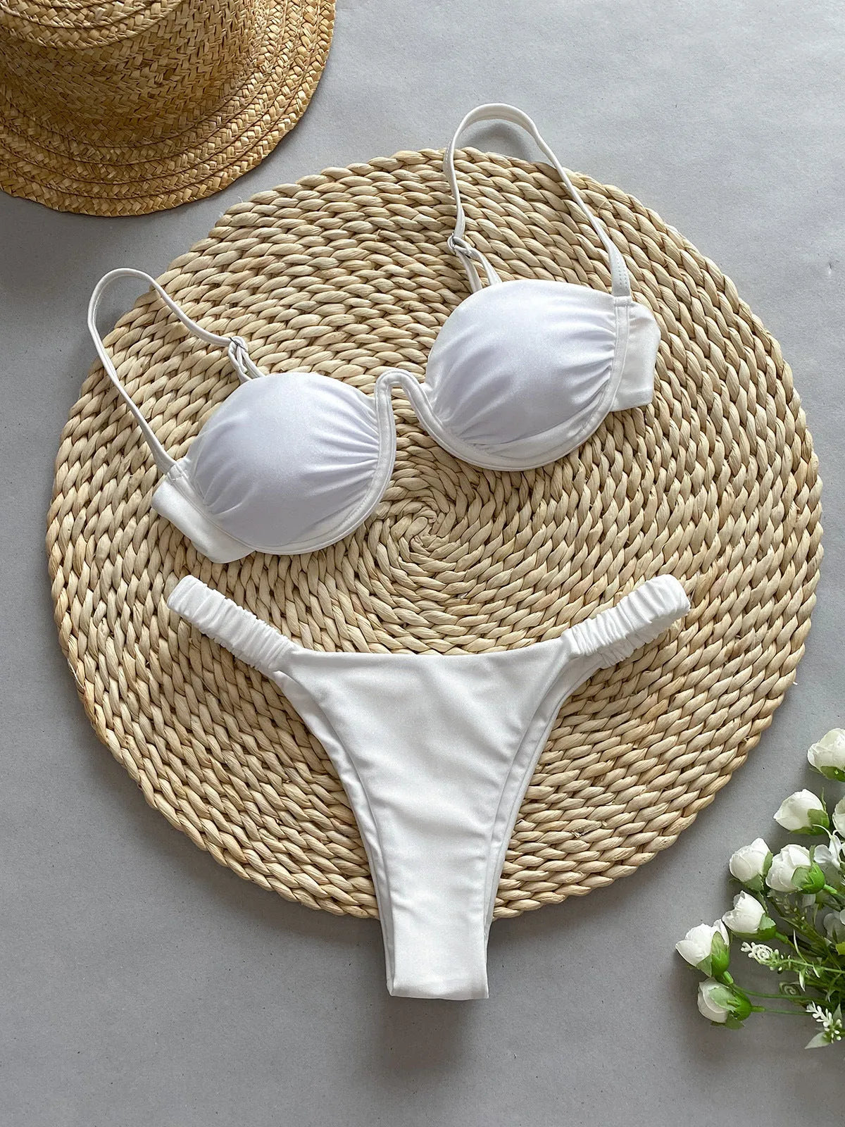 Women's black underwire bikini swimsuit on a mannequin, showing briefs style.