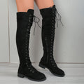Black lace-up over the knee boots with round toe and flat rubber sole on a neutral background.