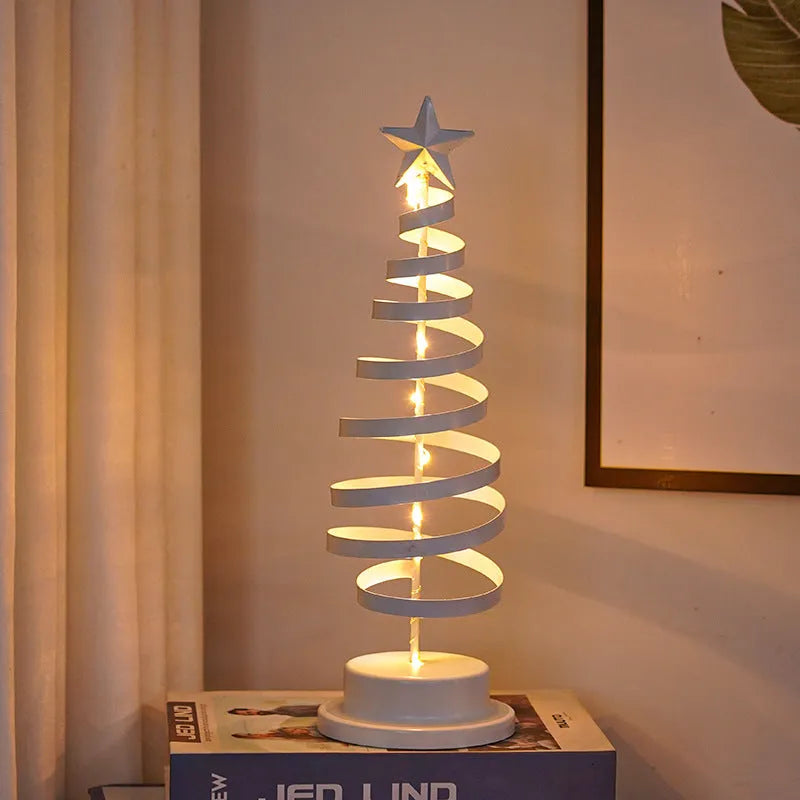 Wrought iron LED Christmas tree spiral light on a table, glowing warm white.