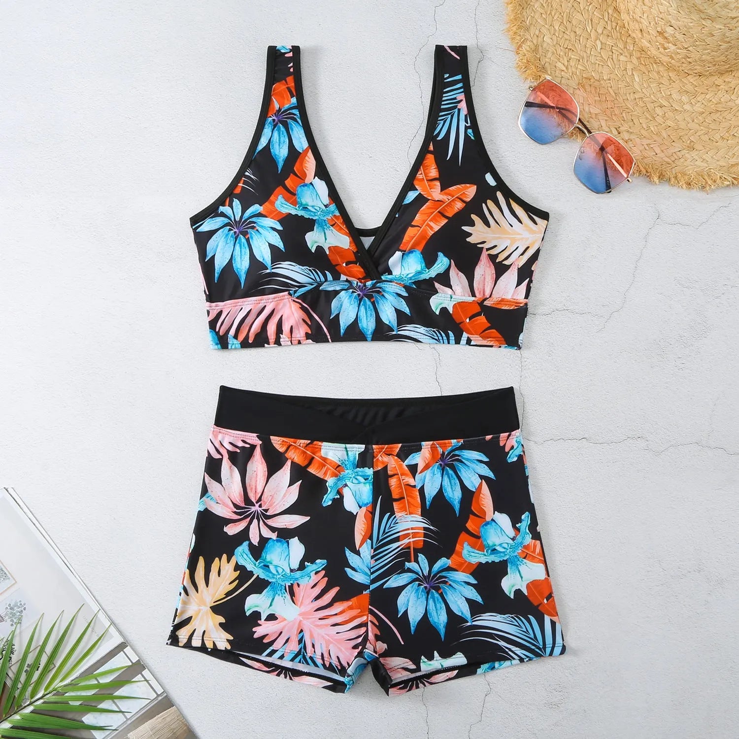Women's two-piece swimsuit with sleeveless top and printed boxer brief bottoms in a multi-colour pattern.