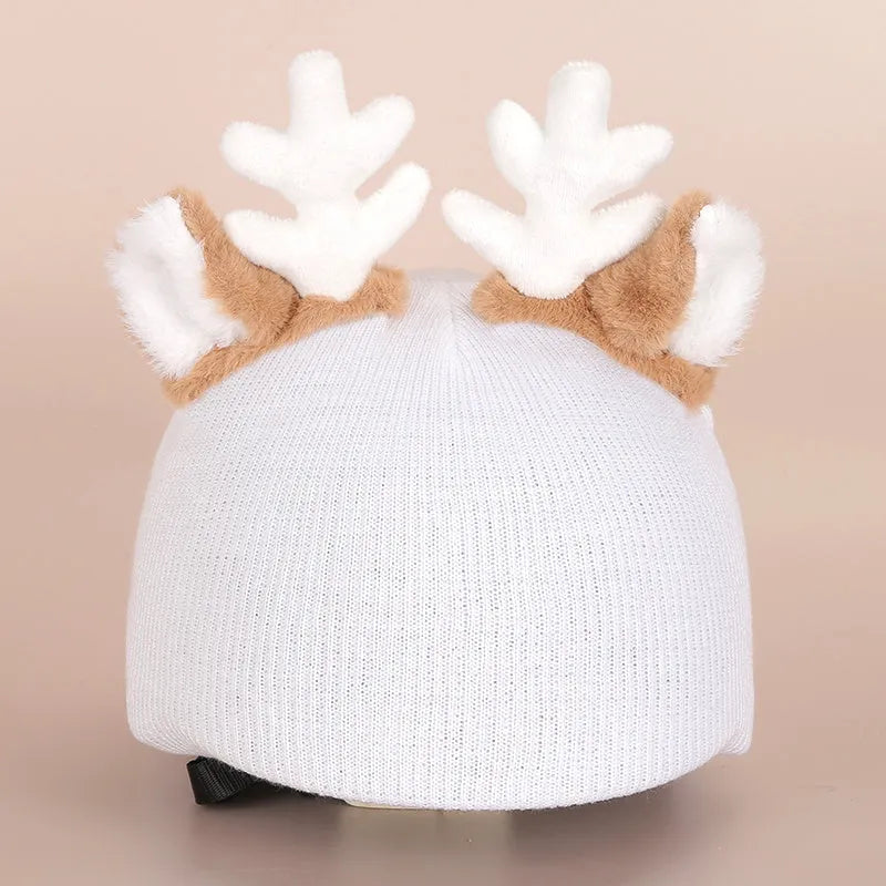 Colourful plush cartoon hat decoration sitting on top of a ski helmet