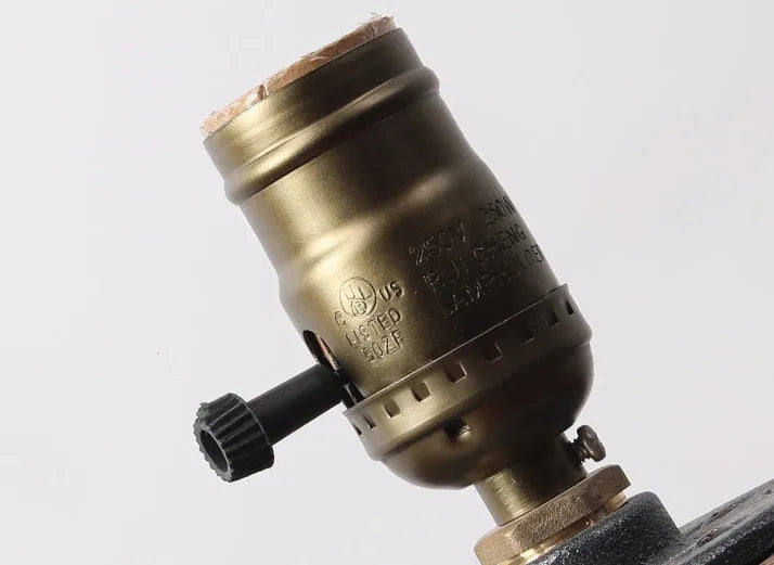 Wood and iron water pipe design table lamp on a surface
