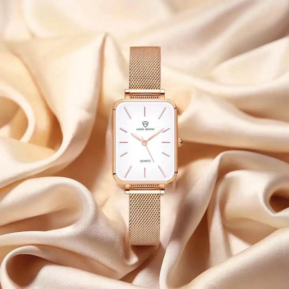 Rose gold and silver women's waterproof quartz watch with woven steel strap on a wrist.