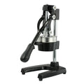Black ductile cast iron manual citrus juicer with stainless steel strainer on a kitchen counter