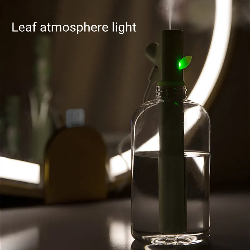 Transparent portable USB air humidifier with adjustable mist settings on a desk