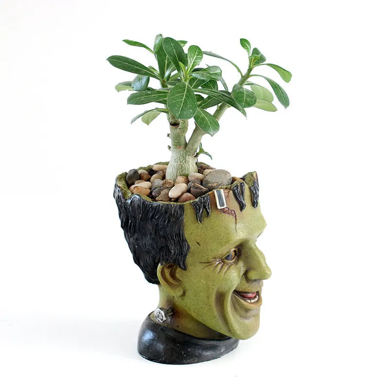 Green personalized resin flower pot with Frankenstein container design and drainage holes for desktop plant display