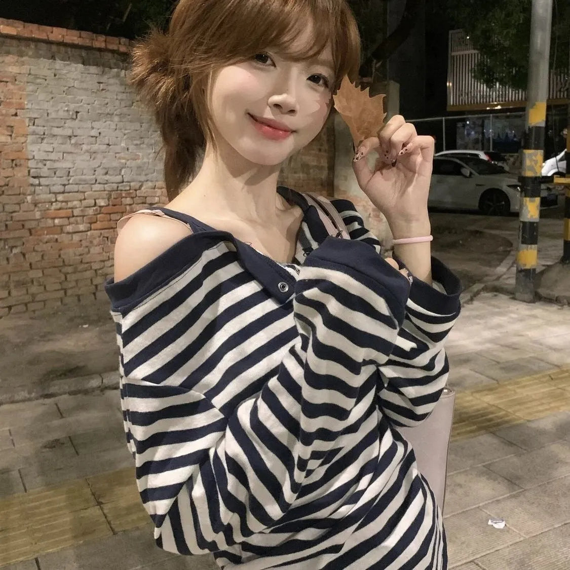 Dark blue oversized long-sleeved women's T-shirt with stripes and embroidery details.