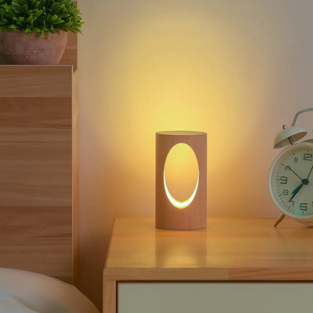 Solid wood LED reading lamp with glass lampshade on a desk, USB cable visible