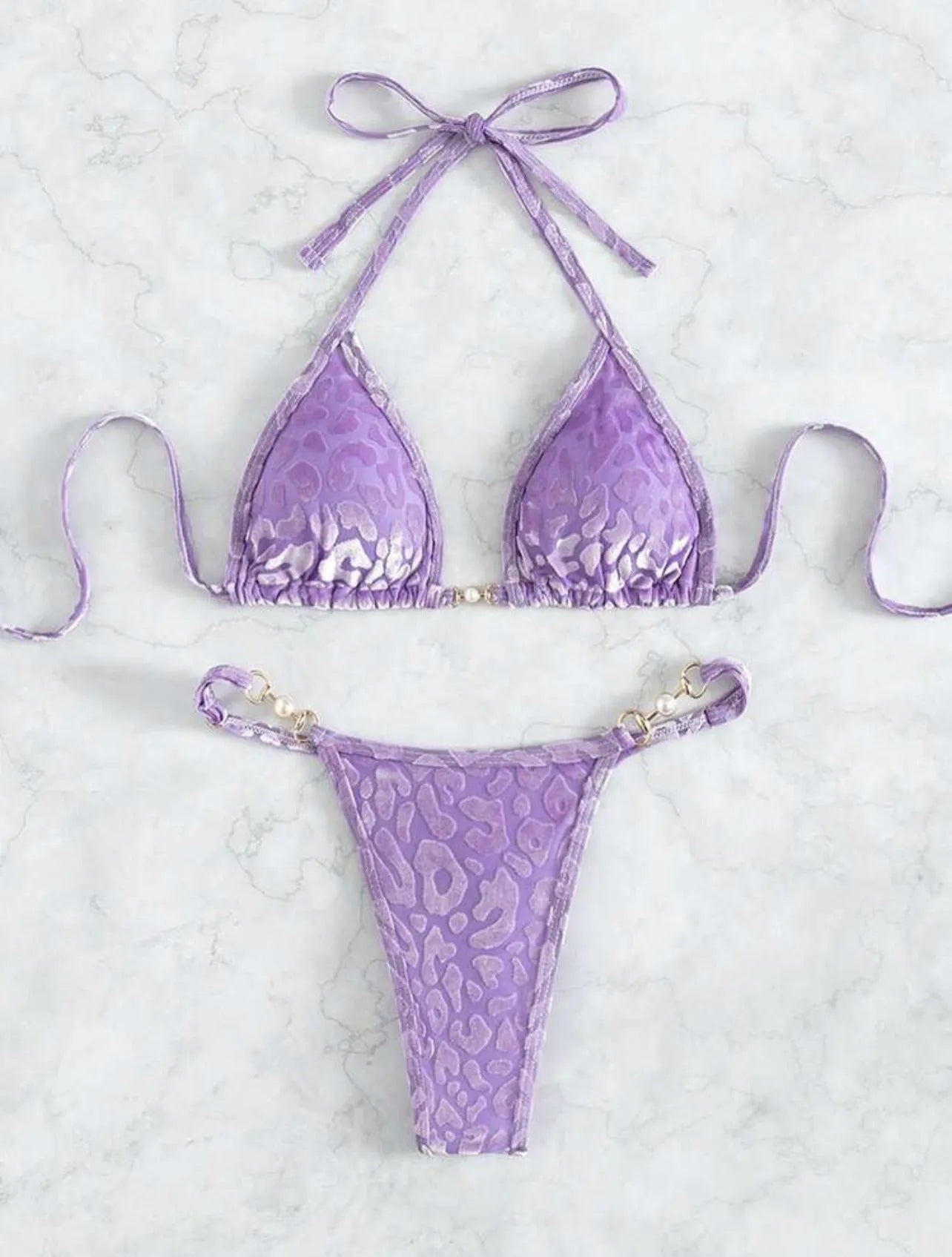 Women's T-shaped leopard print bikini swimsuit in polyester and spandex fabric on a mannequin.