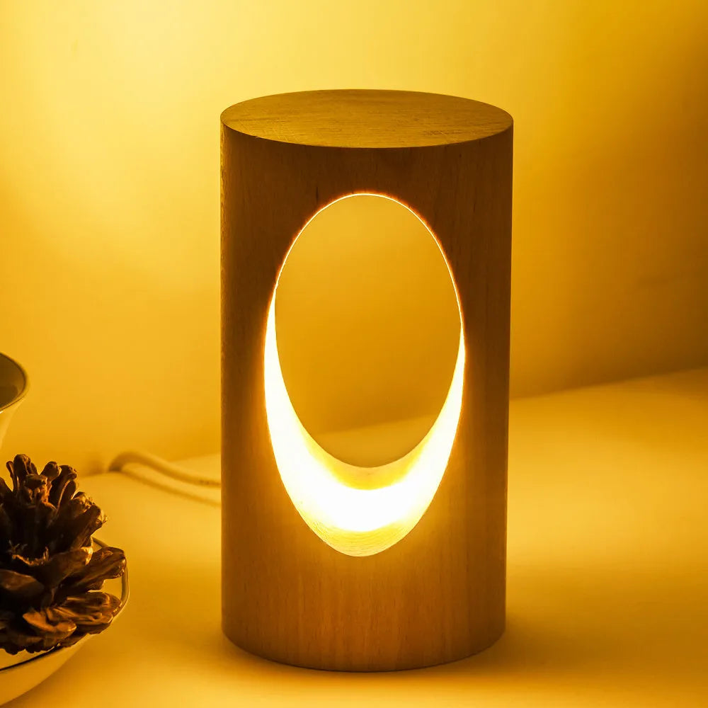 Solid wood LED reading lamp with glass lampshade on a desk, USB cable visible