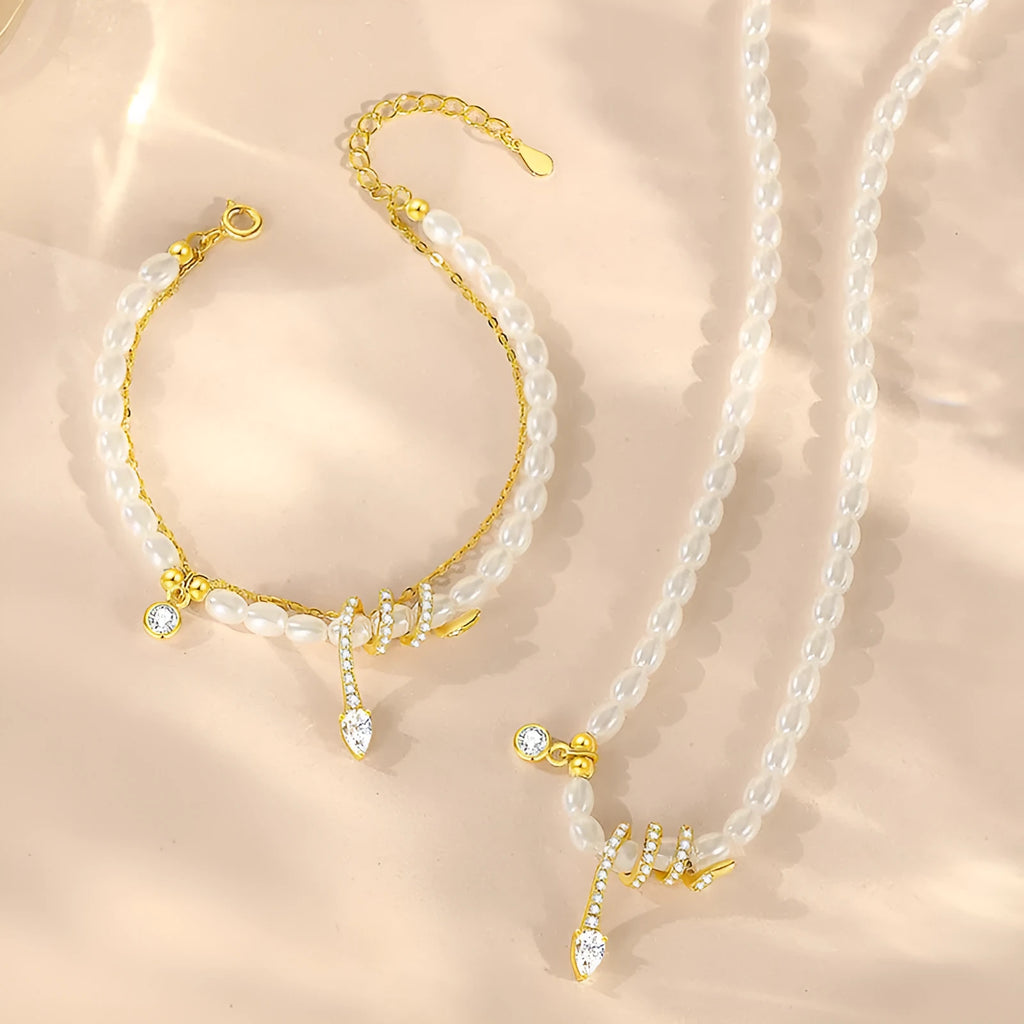 Close-up of a women's silver bracelet with a detailed pearl snake design, shown in both gold and white gold colour options.