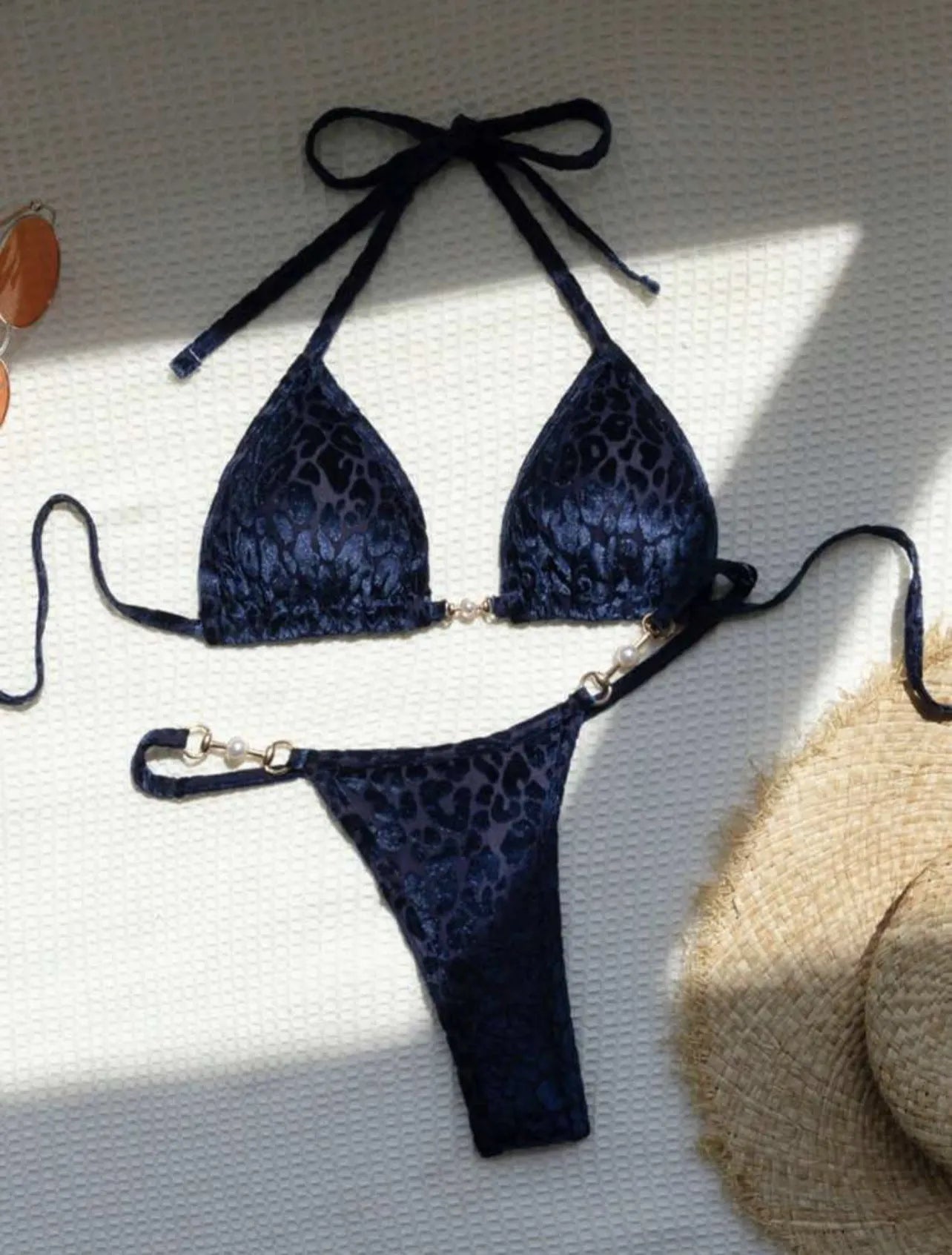 Women's T-shaped leopard print bikini swimsuit in polyester and spandex fabric on a mannequin.