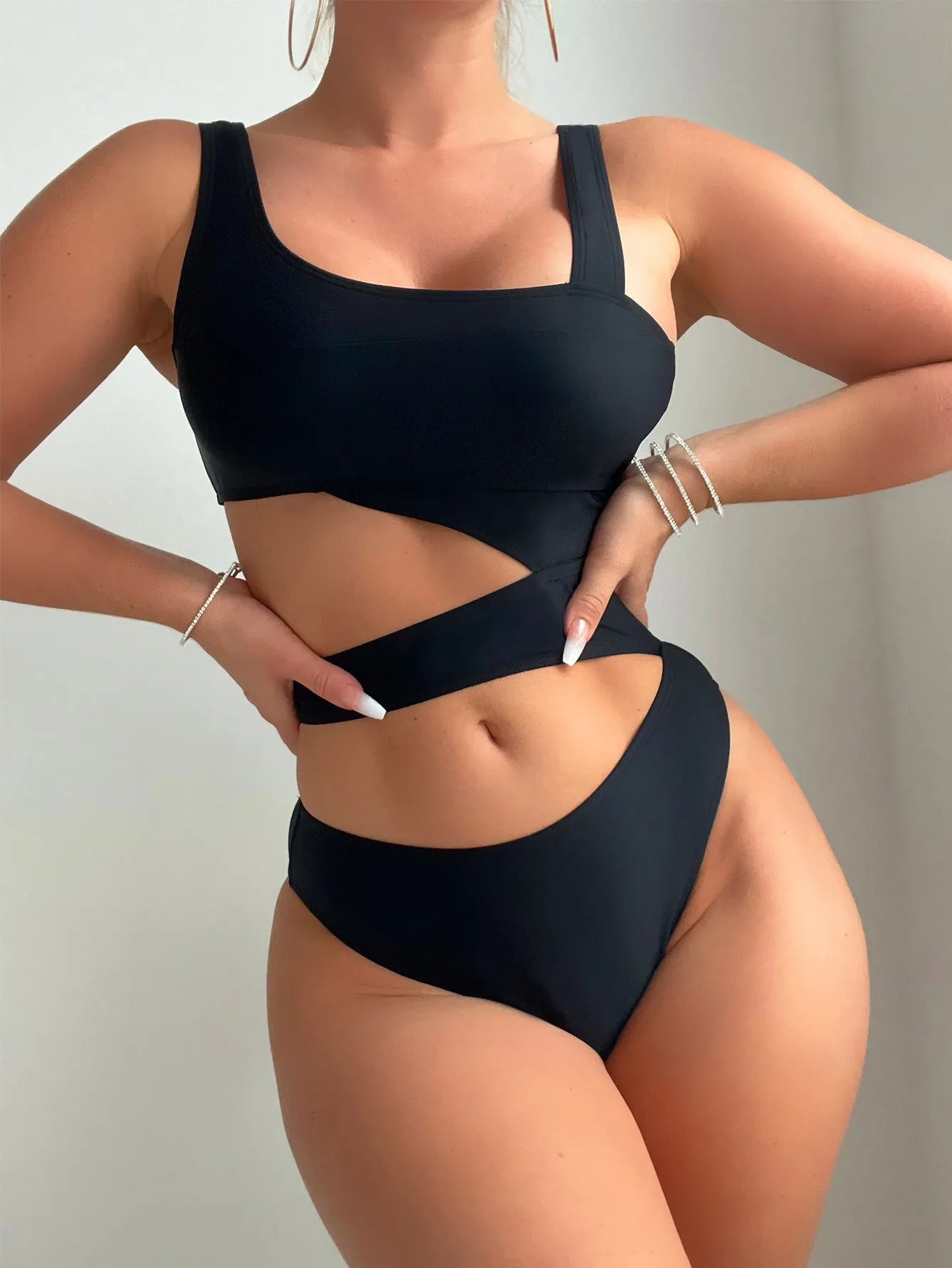 A solid black women's one-piece swimsuit with a high cut leg design on a mannequin.