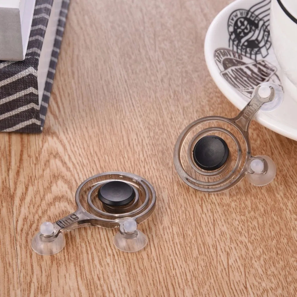 A pair of clear and black universal mini joysticks for mobile phone touch screen gaming.