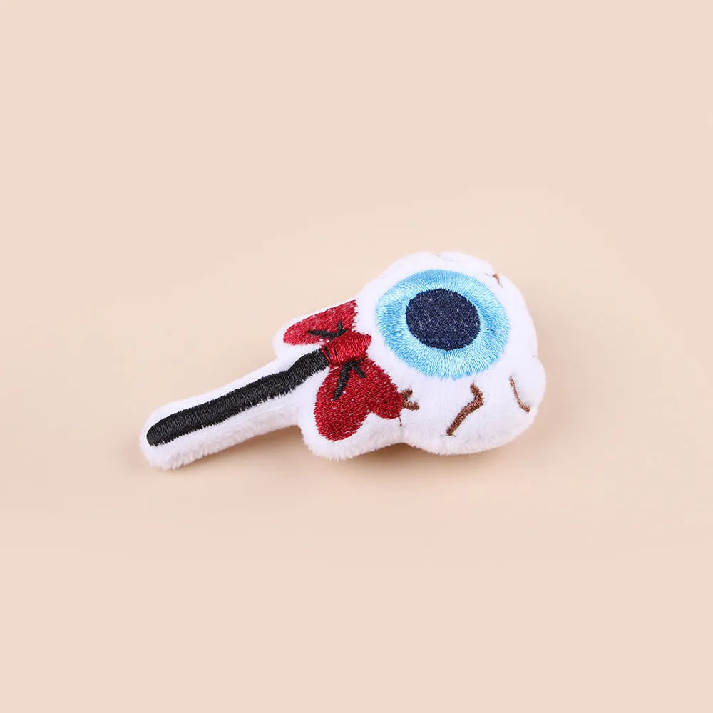 Small colourful plush cat teaser wand with candy, eyes, and skull designs