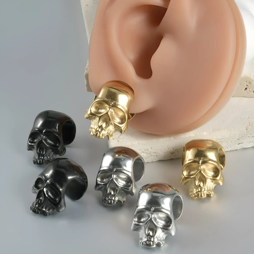 Stainless steel hollow geometric skull and Buddha head earrings in four colour options.