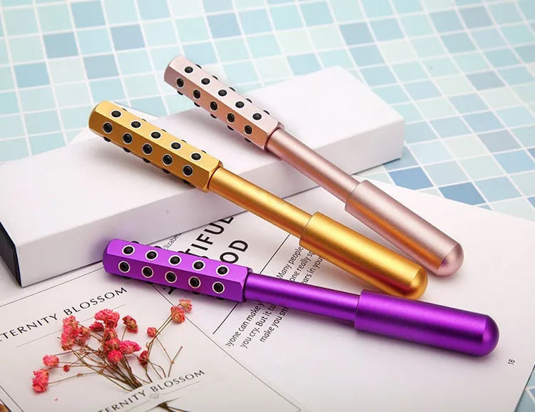 Purple germanium particle facial massage roller on a white background.