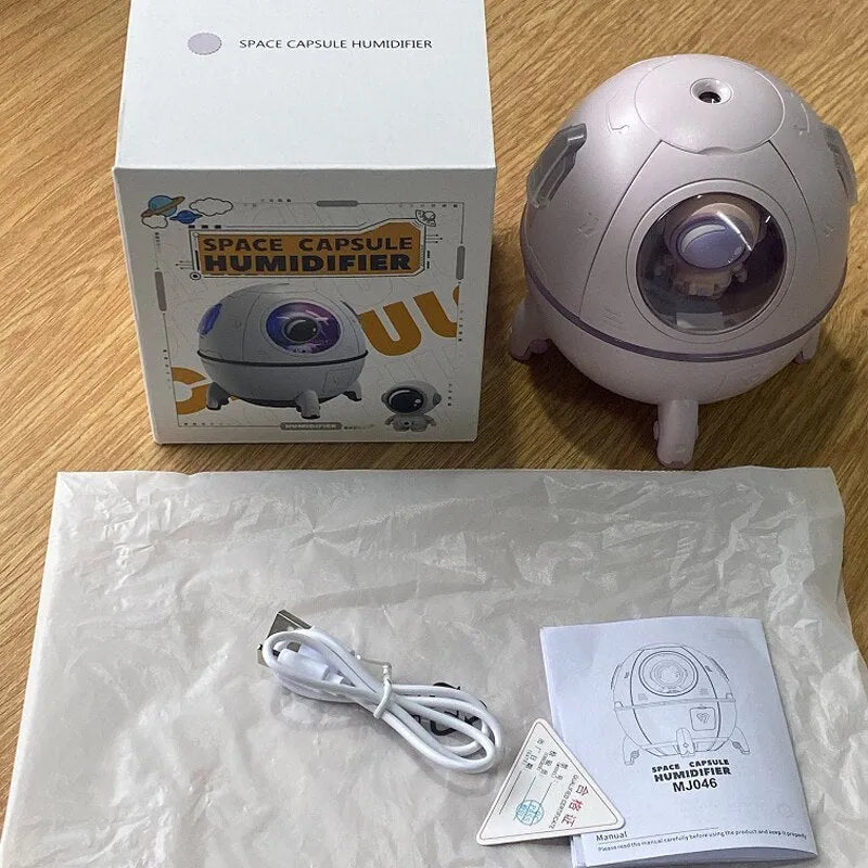 Purple astronaut-shaped USB desktop humidifier with colourful LED light on